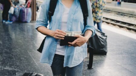 wanita membawa uang dolar di dompetnya