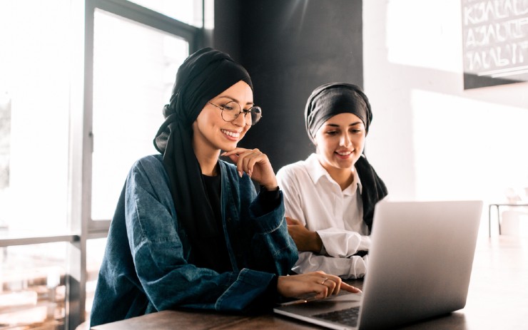 dua orang perempuan berhijab sedang mempromosikan bisnisnya secara online